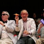Nobel laureates Robert Kirshner, Dudley Herschbach, and Rich Roberts, from left, fire paper airplanes back at the audience during the Ig Nobel Prize ceremony